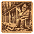 Bigfoot Relaxing with Coffee on his Cabin Porch – Cozy Sasquatch Cork Coaster