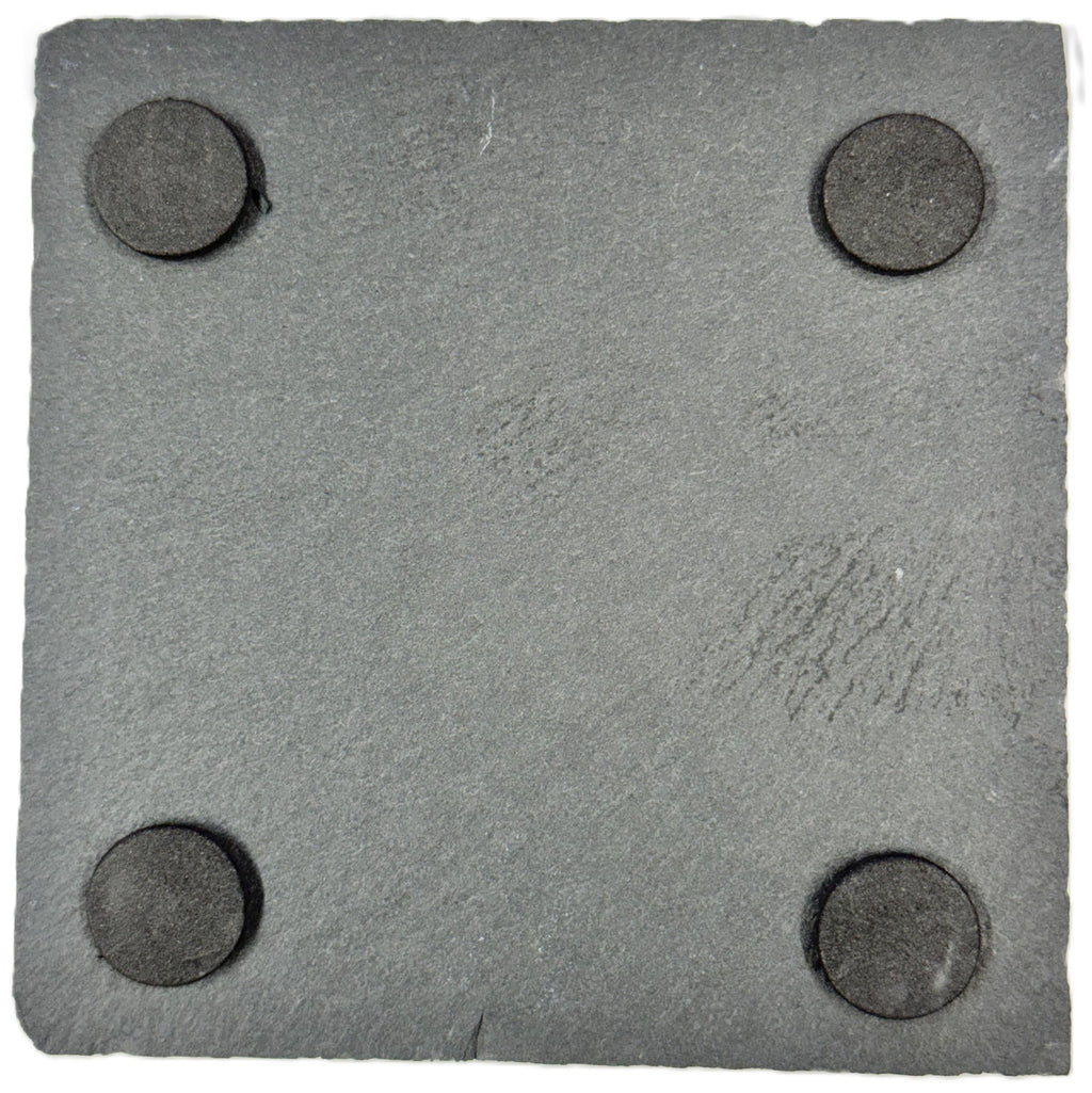 a square gray slate with four circular magnets attached to it.