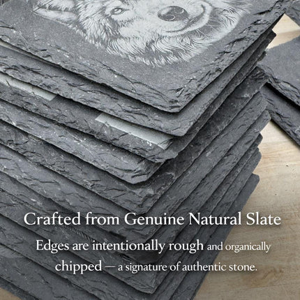 A stack of natural slate coasters with a detailed image of a wolf's face on them.